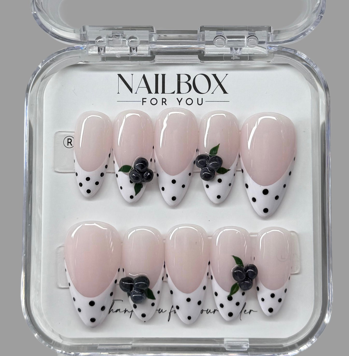Nail art set with polka dot and floral design in a clear 'NAILBOX FOR YOU' packaging.