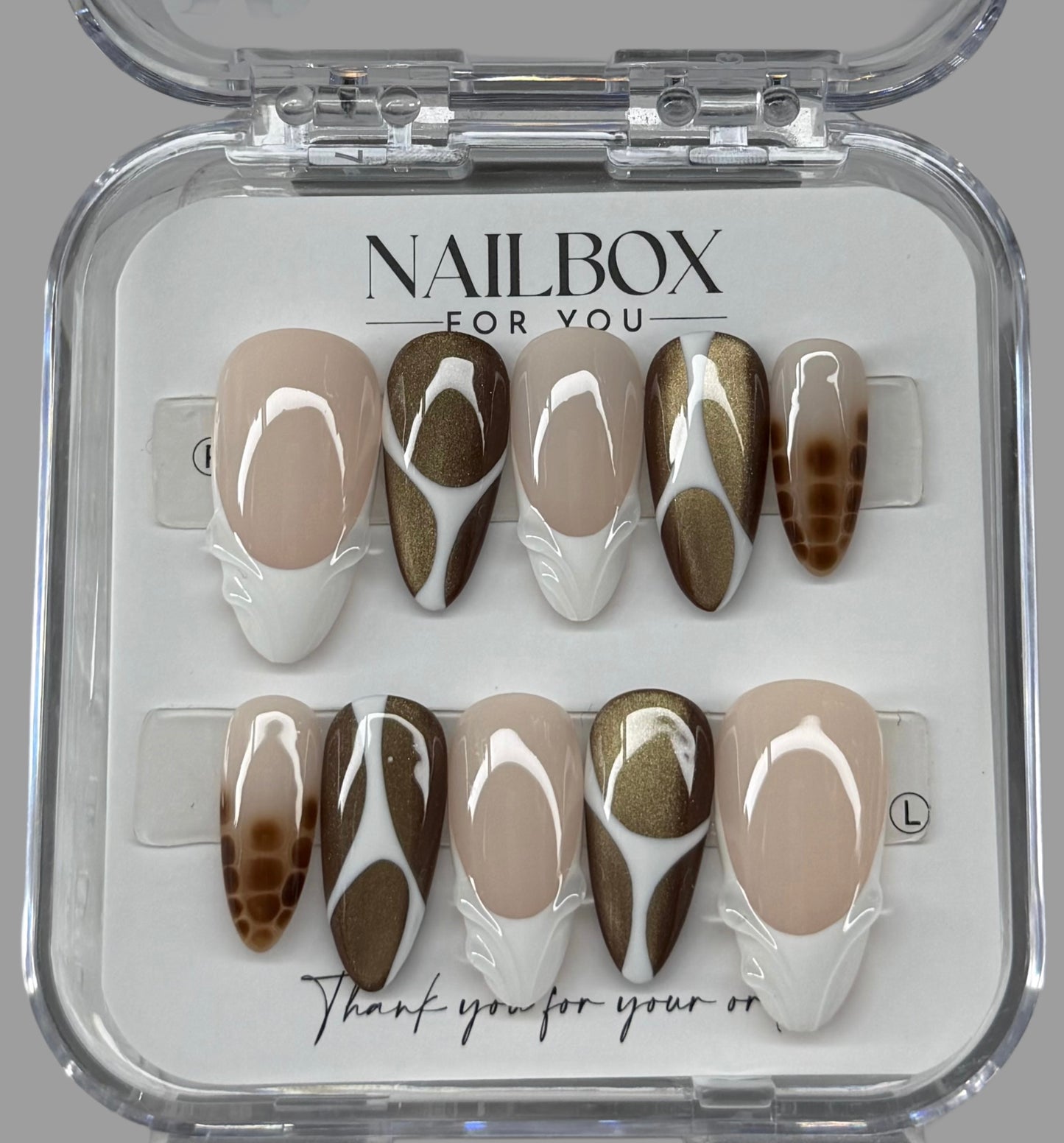 Nail art display with brown and white design
