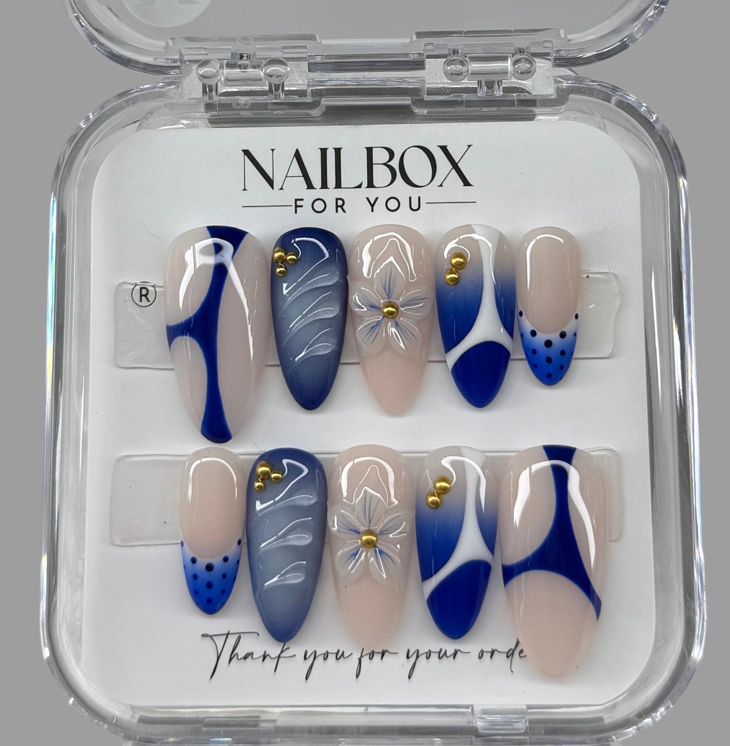 Nail art set with blue and beige designs in a clear 'NAILBOX FOR YOU' packaging.