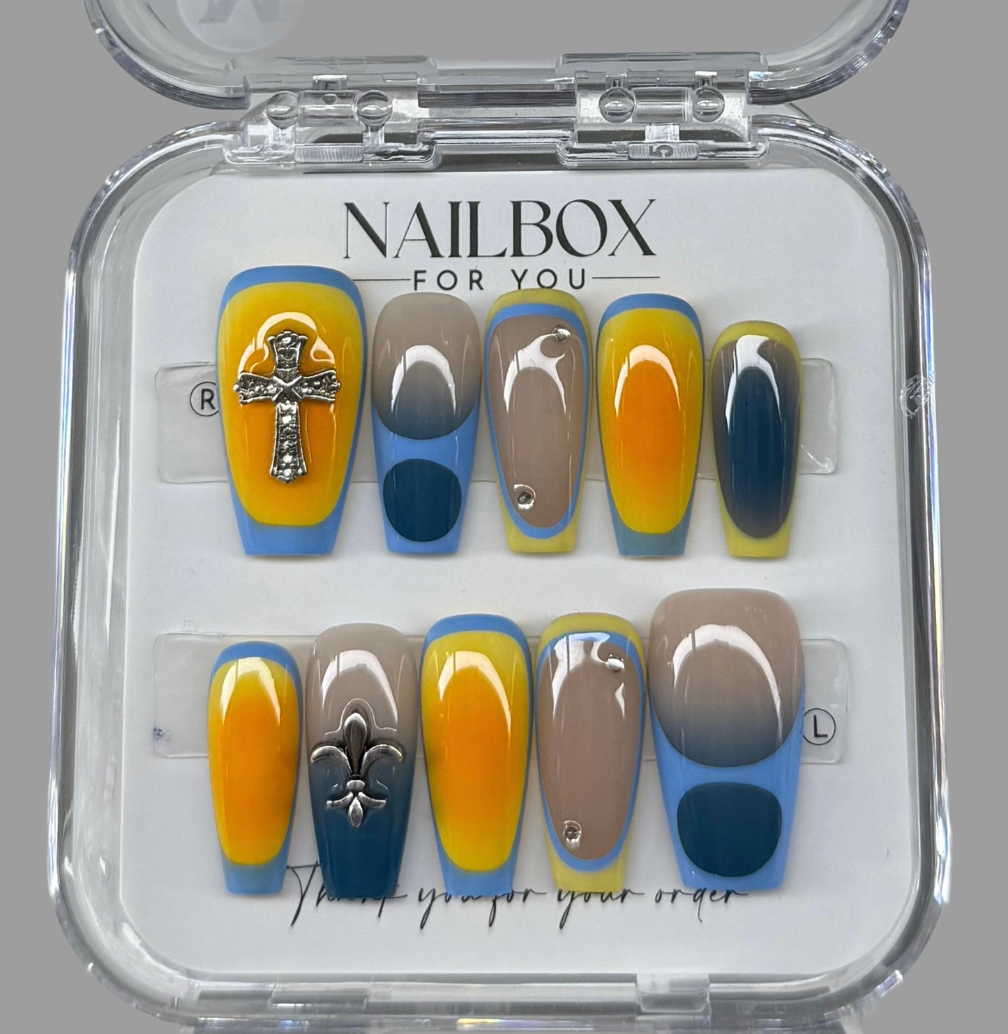 Nail art set with blue, yellow, and brown designs in a clear 'Nailbox for You' packaging.