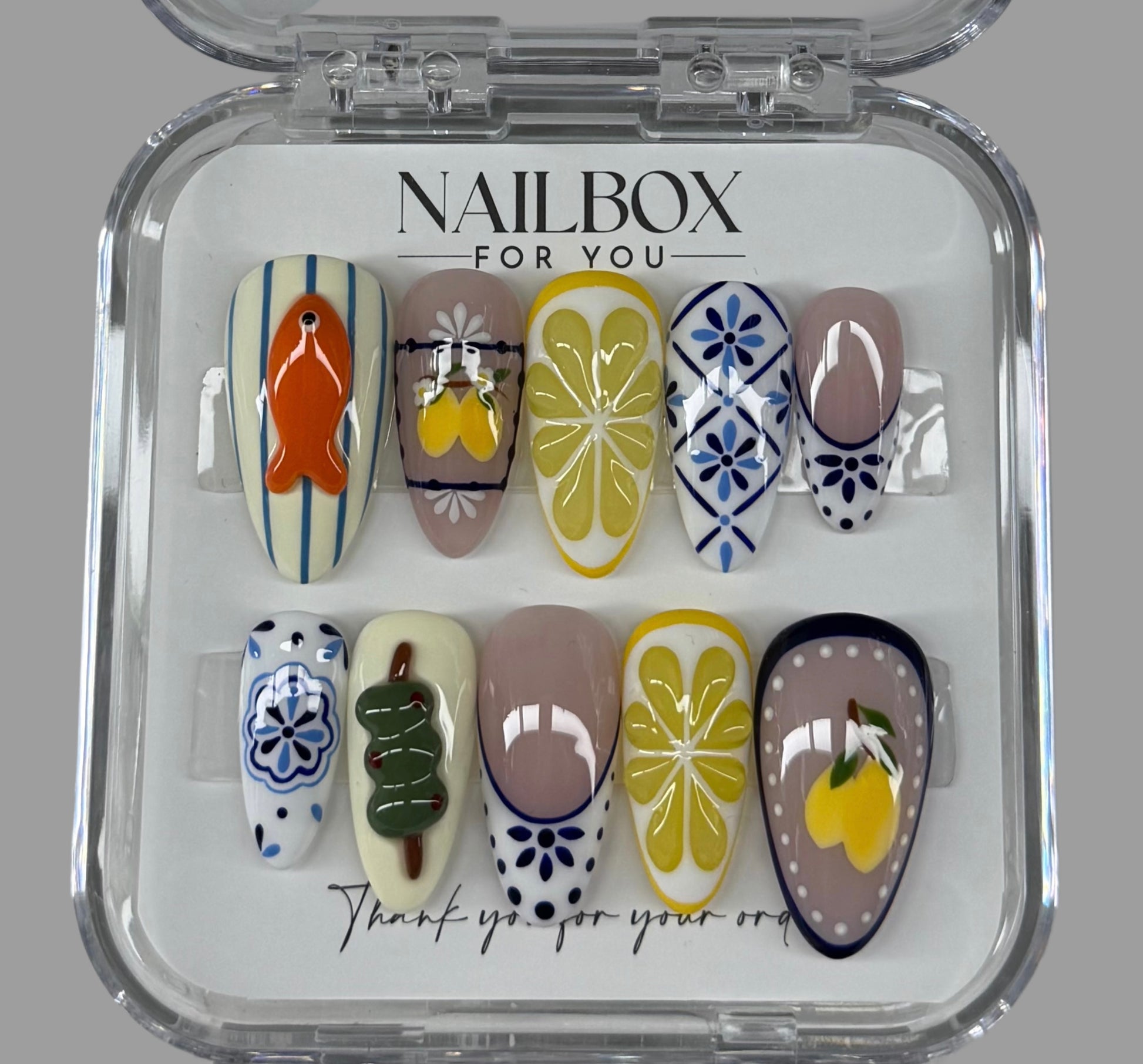 Nail art display with various designs in a clear case labeled 'Nailbox for You'.